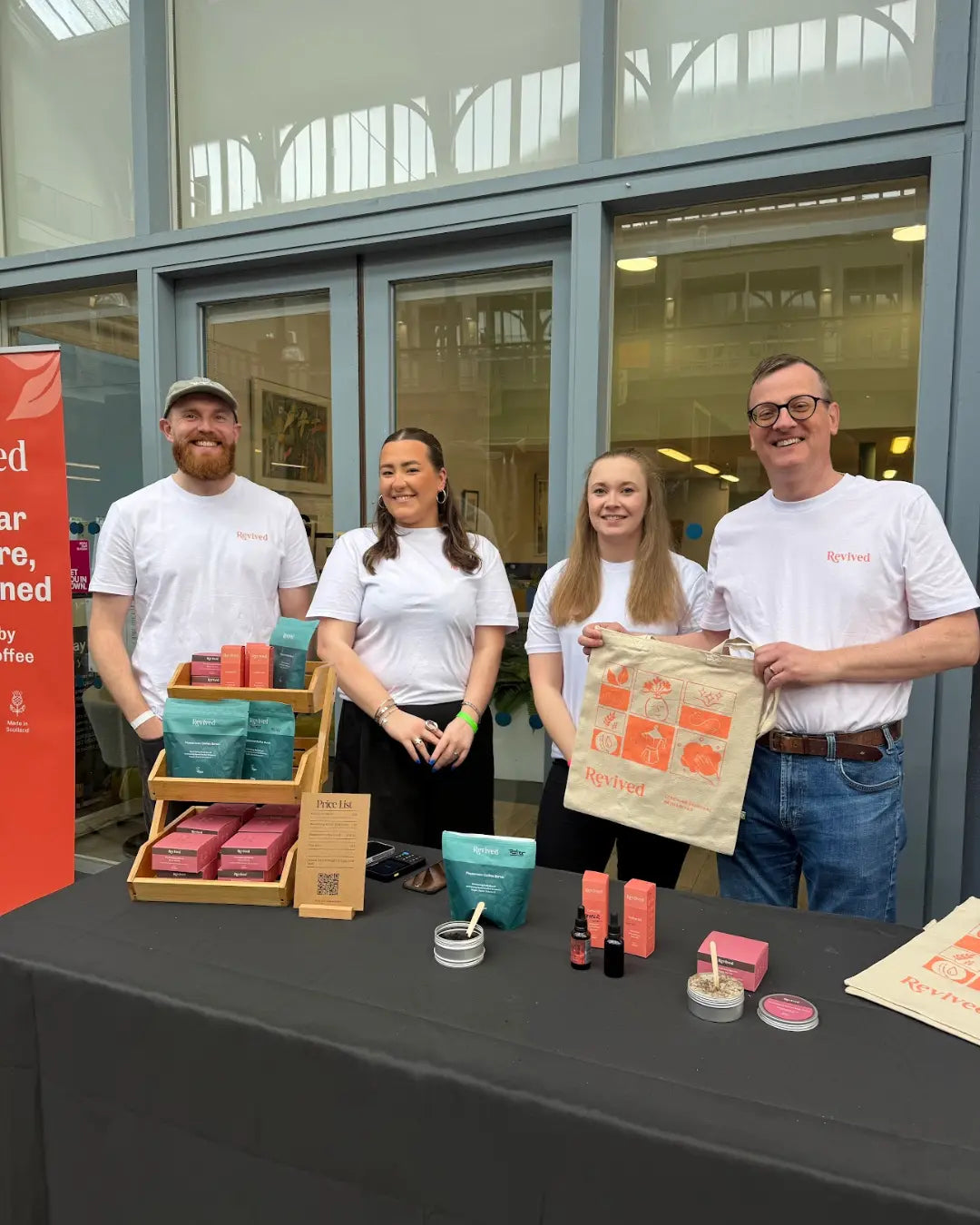 The Revived Team, all dressed in branded tee-shirts, exhibiting at the Glasgow Coffee Festival 2026.