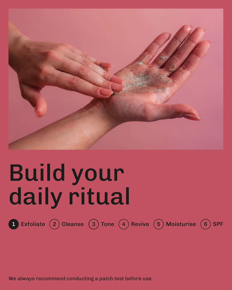 Two hands applying a Revived mocha body scrub with text on a pink background