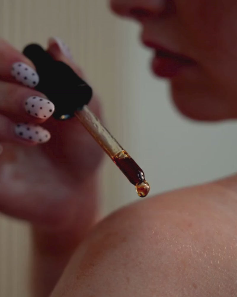 Revived coffee oil being shown applied to skin and massaged in