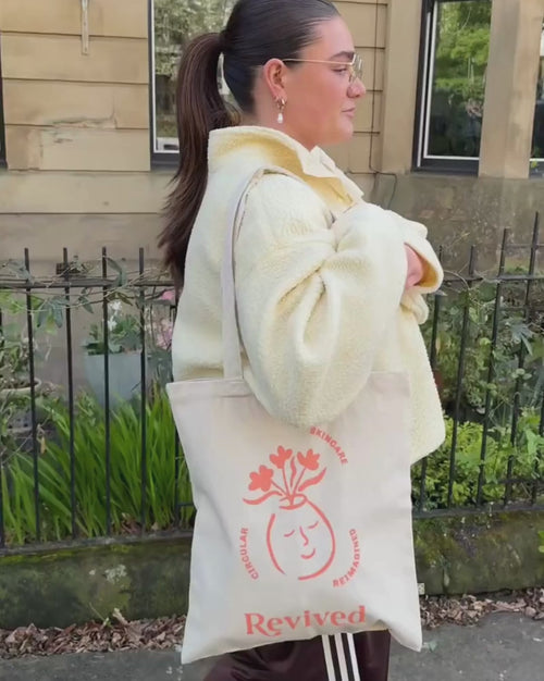 Revived wellbeing icon tote bag being used by a female model