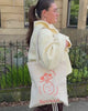 Revived wellbeing icon tote bag being used by a female model